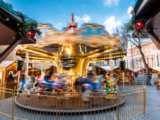 Carousel on motion outdoors in Christmas Market square in Kingston Upon Thames town in winter holiday