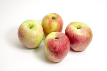 Ripe juicy red-green apples on a white background. Close up. Selective focus.