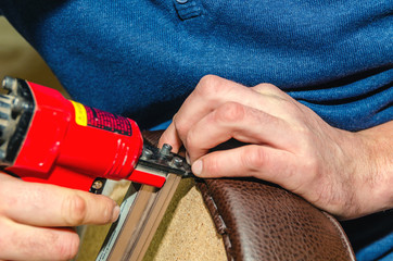 Seat upholstery in a furniture workshop, eco-leather cover