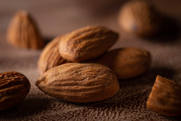 Macro close-up of almonds on acacia cutting board