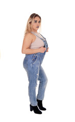 Lovely blond woman standing in profile in working jeans