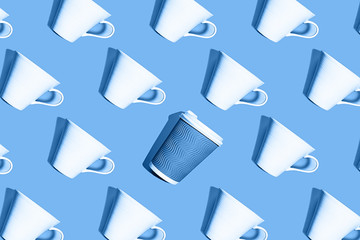 Fototapeta na wymiar Coffee pattern of white ceramic cups and one blue paper cup for coffee on classic blue background.