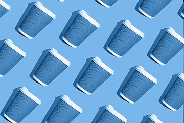 Coffee pattern of blue paper cup for coffee on bright classic blue background.