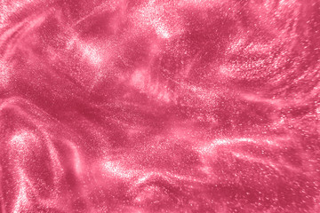 Abstract elegant, detailed pink glitter particles flow with shallow depth of field underwater. Holiday magic shimmering luxury background. Festive sparkles and lights. de-focused.