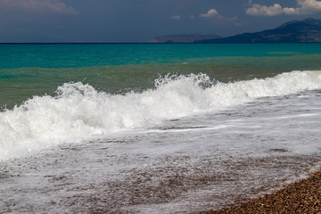 Gravel / pebble beach at the westcoast of Rhodes island near Kattavia with ocean waves