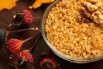 cane sugar and walnut in a dish, macro photo for background or texture