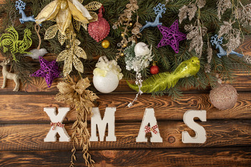 Christmas fir tree with decoration on a wooden background.