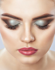 Portrait of a beautiful happy woman with long eyelashes, beautiful smoky eyes make-up, thick...