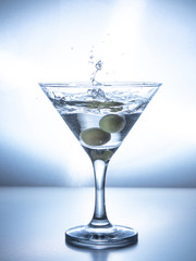 one glass of water with splash from falling ice cube, white background, isolated object