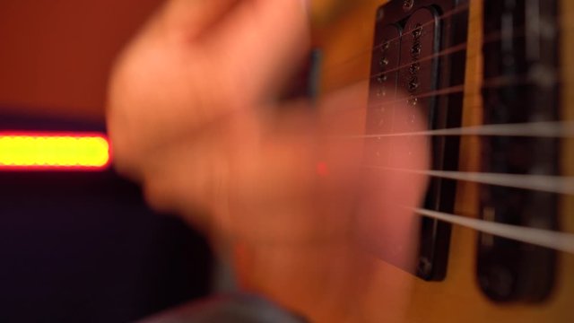 Close up of professional solo guitarist playing electric guitar