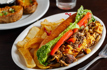 Philly steak and cheese sandwich with French Fries
