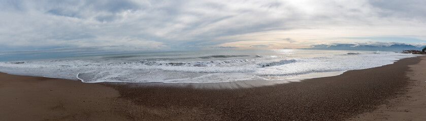 Wavy sea shore panorama at cloudy weather, Lara beach in south Turkey