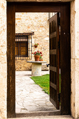 WOODEN DOOR THAT LEADS TO AN INTERIOR COURTYARD