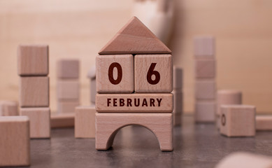 February 6 written with wooden blocks