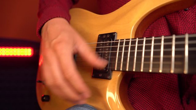 Close up of professional guitarist is playing song