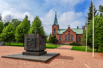 Jyvaskyla, Finland - August 10, 2017  Taipale Battle Monument in Kirkkopuisto park of Jyvaskyla city in Central Finland. The church Kaupunginkirkko is at background.