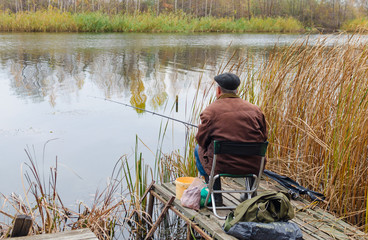 Fisherman catches fish on the river bank