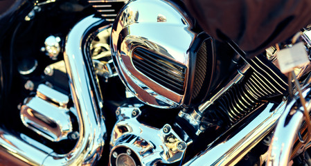 Close up background, part of modern chrome shiny engine of motorcycle, full frame, no people