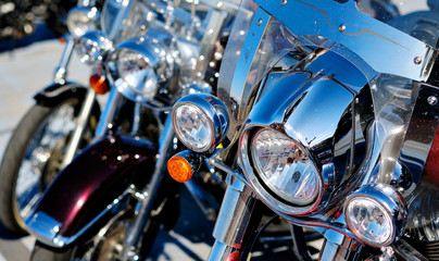 Modern motorcycle headlights close up view outdoors, part of vehicle front view