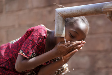 Portrait Close up of African Black Child Girl Drinking Fresh Water