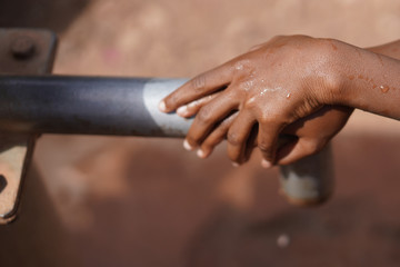 African Children at School Drinking Fresh Water from a Tap