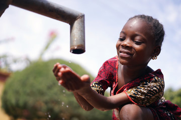 Close up Photograph of African Black Girl Drinking Safe Water from Tap