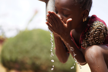 Human Rights and Climate Change Symbol: African Black Ethnicity Girl Woman Drinking Safe Water - obrazy, fototapety, plakaty