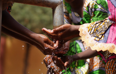 Hands under Tap from African Black Children with Fresh Clean Water