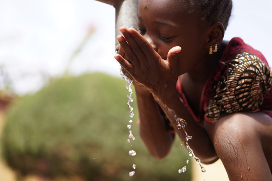 Human Rights and Climate Change Symbol: African Black Ethnicity Girl Woman Drinking Safe Water