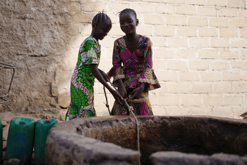 Close Up of two beautiful African Girls with Water Well