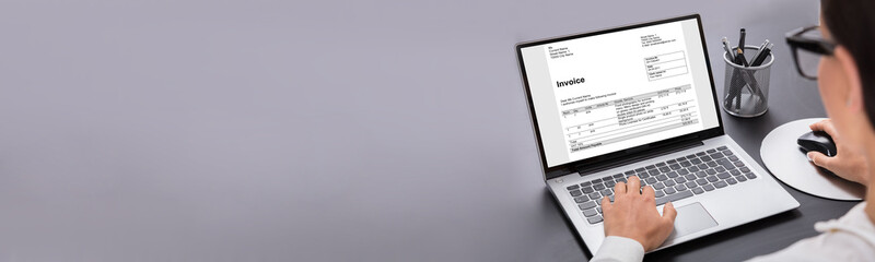 Businesswoman Looking At House On Laptop