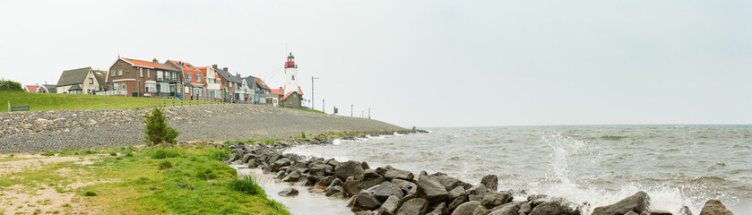 Panorama of the port town of Urk, view from the beach, lighthouse. - obrazy, fototapety, plakaty