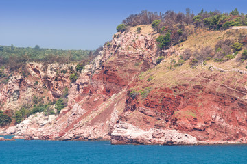 Beautiful landscape of Mediterraen Sea. Blue water and red rocks.