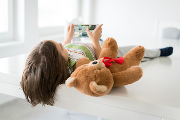 Child at home with Teddy bear