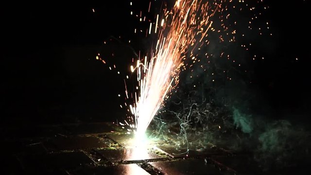 Firework exploding on the ground slow motion