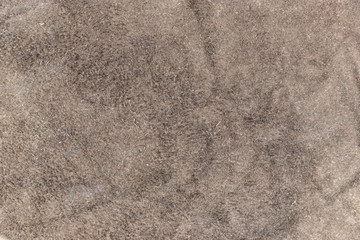 Back of a piece of brown died textured wrinkled leather for background