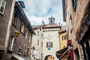 Beautiful typical narrow street in small european town with vintage buildings on cloudy sky background. Photography with old houses facades.