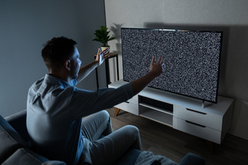 Man In Front Of Television With No Signal