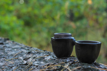 Tea ceremony. Teapot and bowls with Chinese tea on a wooden table. Drink, traditional, japan, health, beads, buddha, asia, asian, background, bamboo, beverage