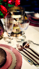 fancy dishes and silverware and drinking glass closeup for the concepts of table setting and events arrangement
