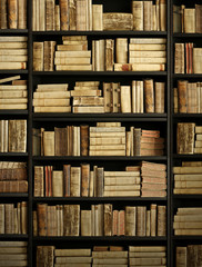 antique books on old wooden shelf.