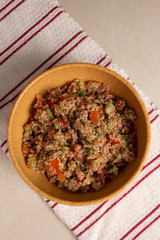 Traditional Arabic Salad Tabbouleh with couscous, vegetables and greens
