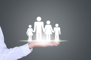 Closeup male businessman holding family of four, love and family relationship concept.