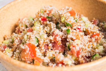 Traditional Arabic Salad Tabbouleh with couscous, vegetables and greens