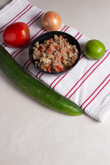 Traditional Arabic Salad Tabbouleh with couscous, vegetables and greens