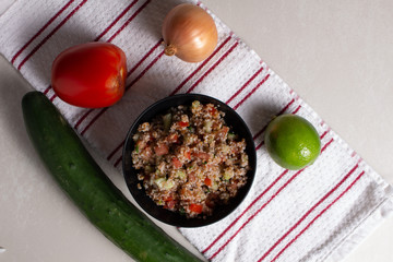 Traditional Arabic Salad Tabbouleh with couscous, vegetables and greens