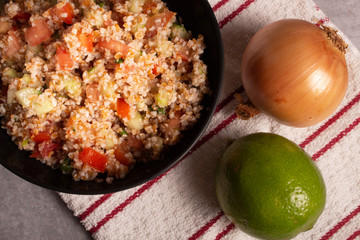 Traditional Arabic Salad Tabbouleh with couscous, vegetables and greens