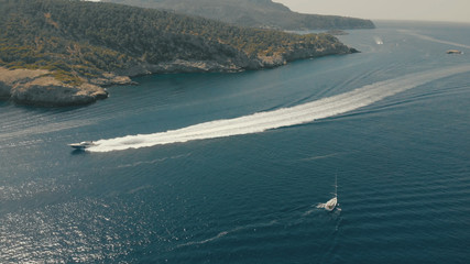Aerial View of yacht near rocky island of Mallorca. Drone footage of yachting around Balearic...