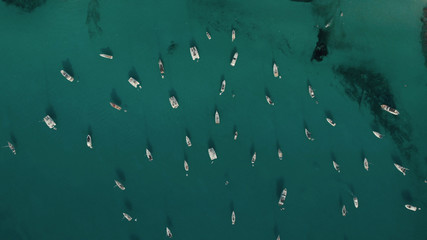 Aerial View of many yachts in a bay on Formentera island. Cala Saona bay drone footage. Yachting in...