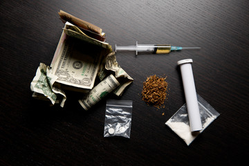 different drugs and crumpled dollars on the table
